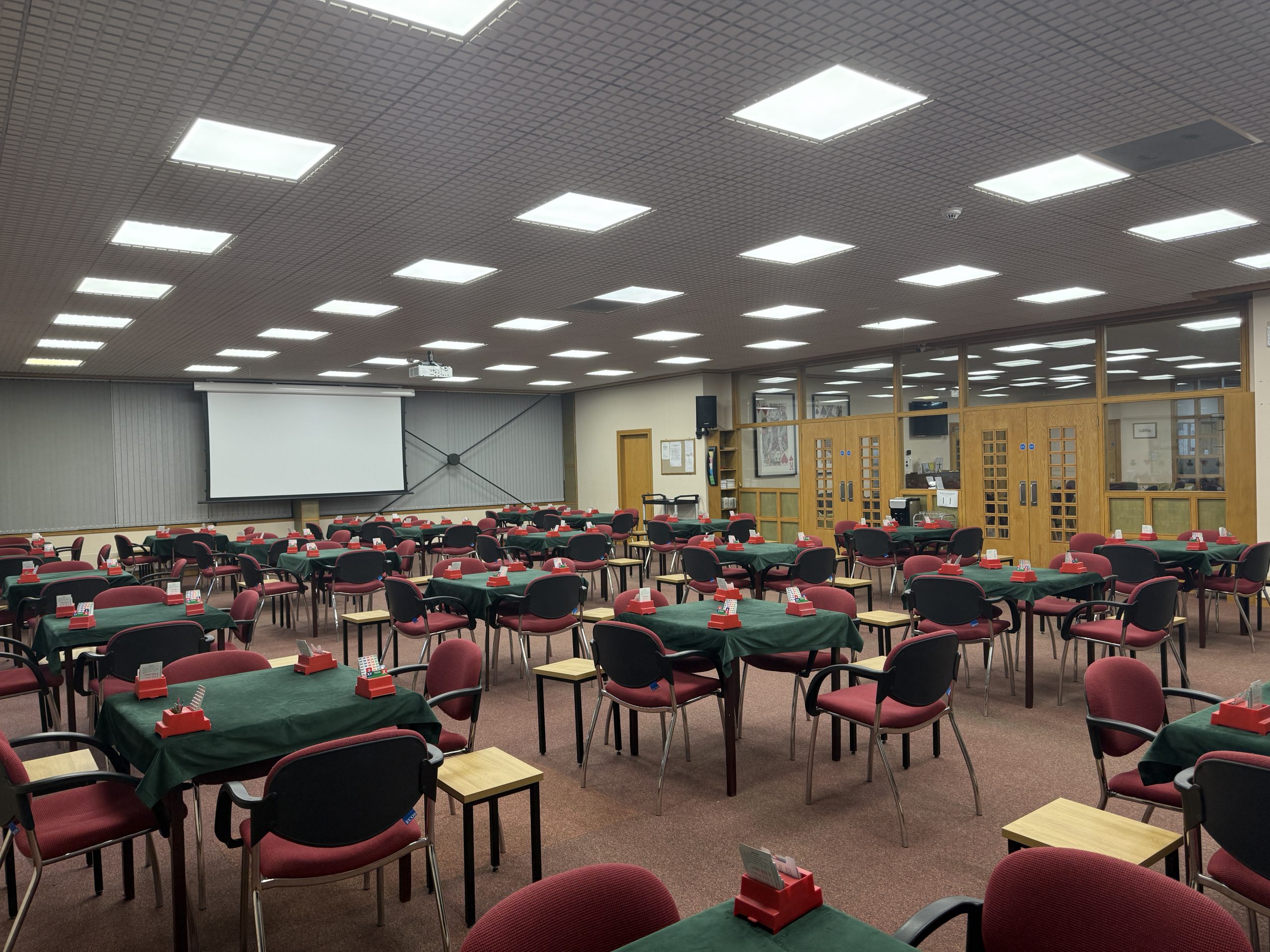 The main playing room laid out with 24 tables